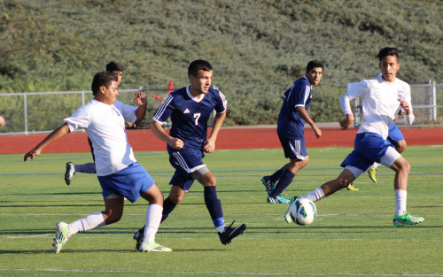 HEADING FOR THE GOAL During a varsity boys’ soccer game against San Gabriel, midfielder Martin Espinoza attempts to maintain his possession of the ball against a couple of defenders. Ultimately, the Moors went on to win with a score of 1-0 against the Matadors.MOOR Photo by SHANNON KHA